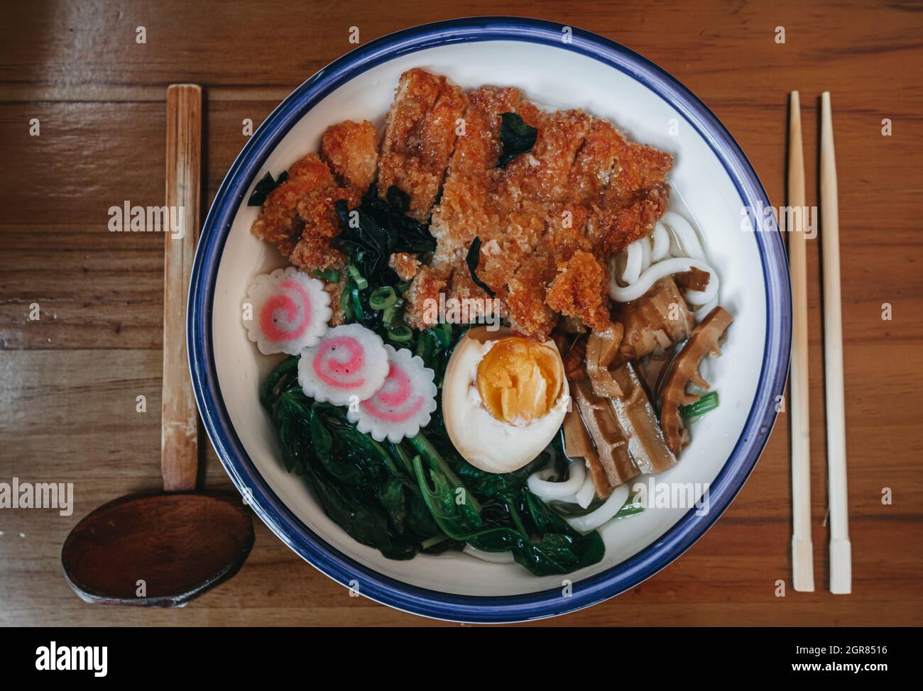 Asian Style Soup With Udon Noodles, Chicken, Boiled Eggs And Spinach In