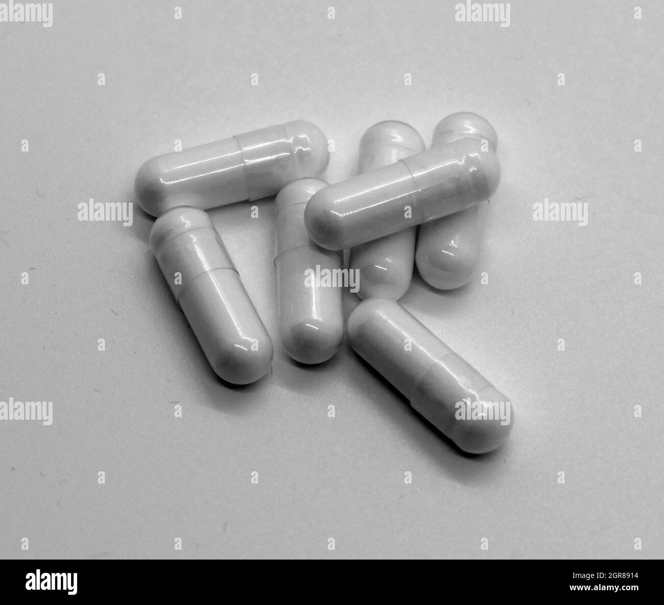 White capsules on white background Stock Photo Alamy