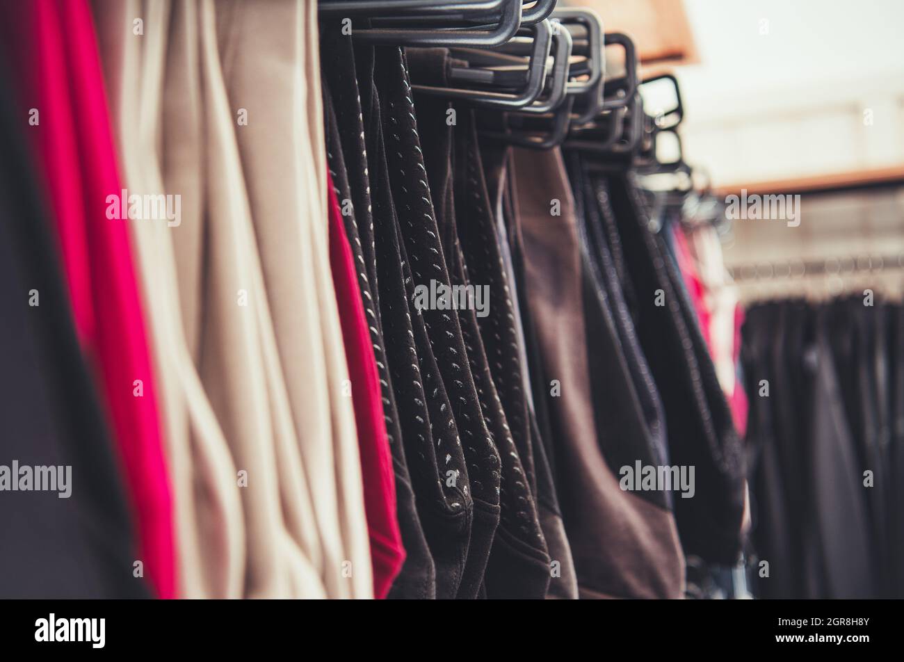Selection Of Woman Clothes Hanging On A Store Rack. Retail Business Theme. Stock Photo