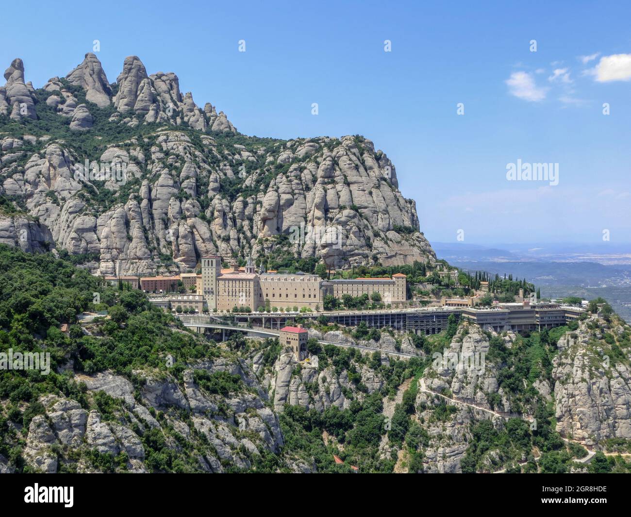 Georgous Monserrat Located At The Top Of The Mountain/plants Growing On Rock By Building Against Sky Stock Photo