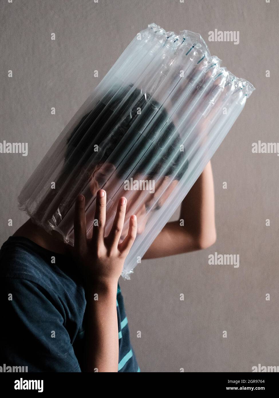 A Boy Head Stuck In Plastic Wrapper Stock Photo Alamy
