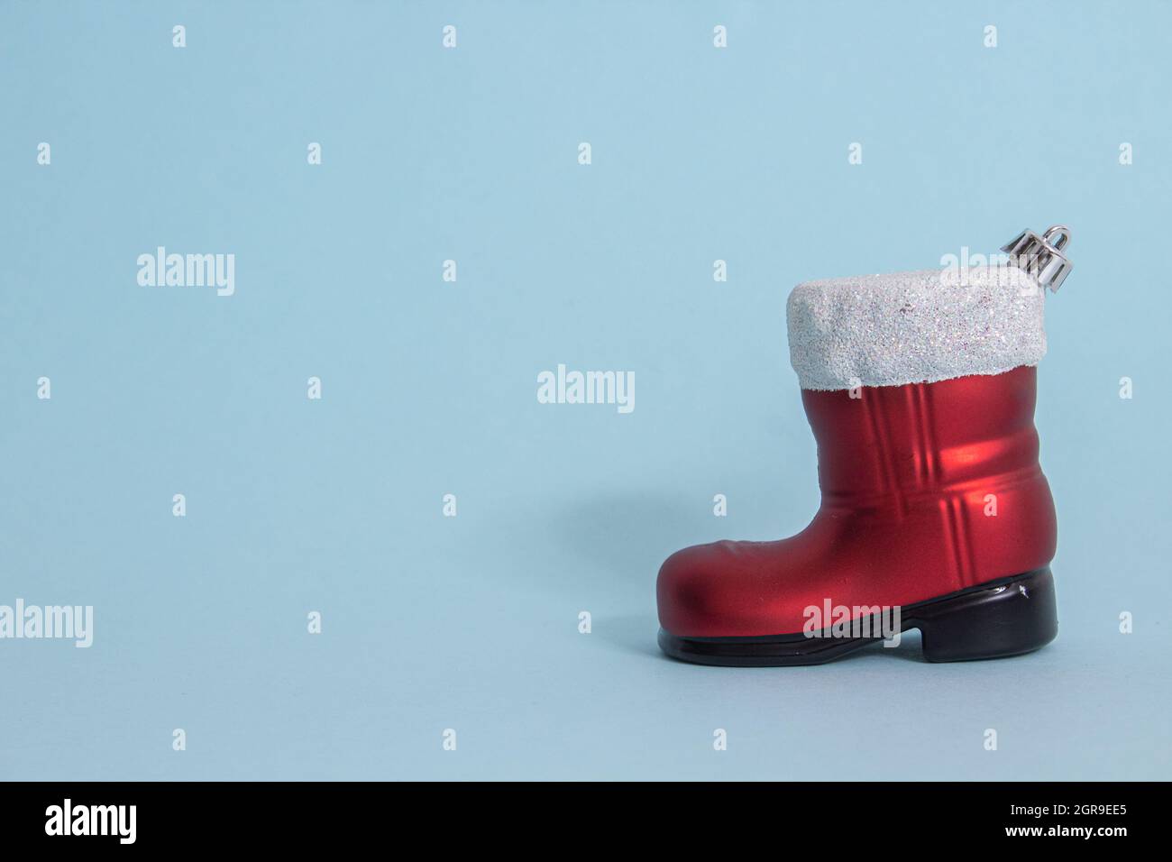 Santa Claus boot isolated on a blue background Stock Photo - Alamy