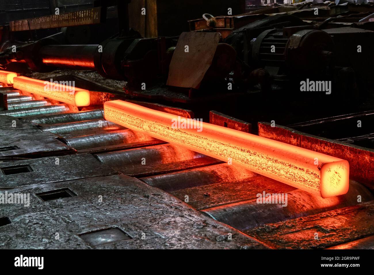 Red-hot metal billet on the roller table of a rolling mill Stock Photo -  Alamy