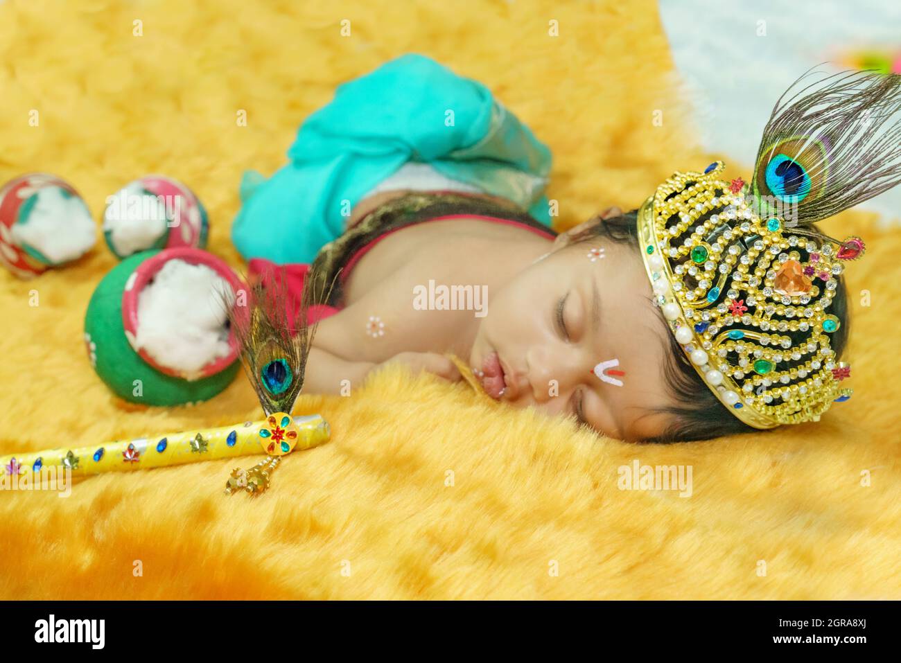 Newborn Baby Sleeping On Bed In An Indian Traditional Attire Stock Photo