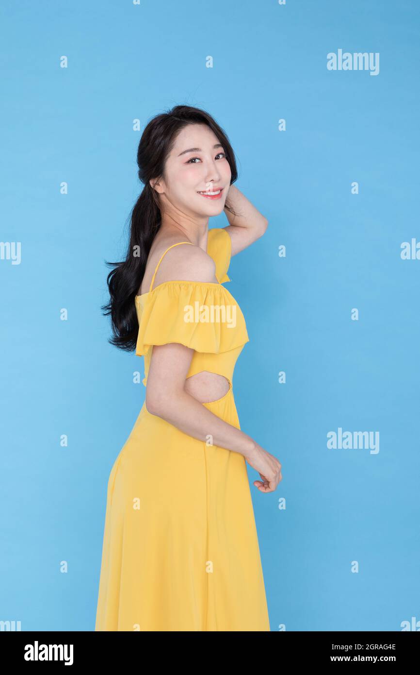 side view of smiling beautiful Korean Asian woman in summer yellow dress skyblue background Stock Photo Alamy