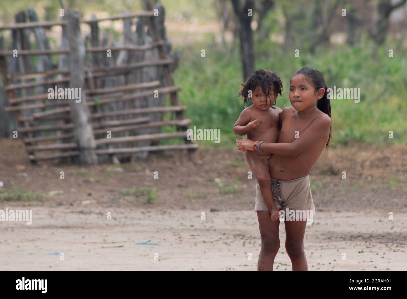 Mayapo, Colombia. 26th Sep, 2021. A small child holds her sisters on her arms during a Humanitarian Mission developed by 'De Corazon Guajira' in Mayapo at La Guajira - Colombia were they visited the Wayuu indigenous communities 'Pactalia, Poromana, Perrohuila' on September 26, 2021. The Guajira region in Colombia is the poorest region in Colombia, with its people commongly living without drinkable water, electricity and food. Credit: Long Visual Press/Alamy Live News Stock Photo