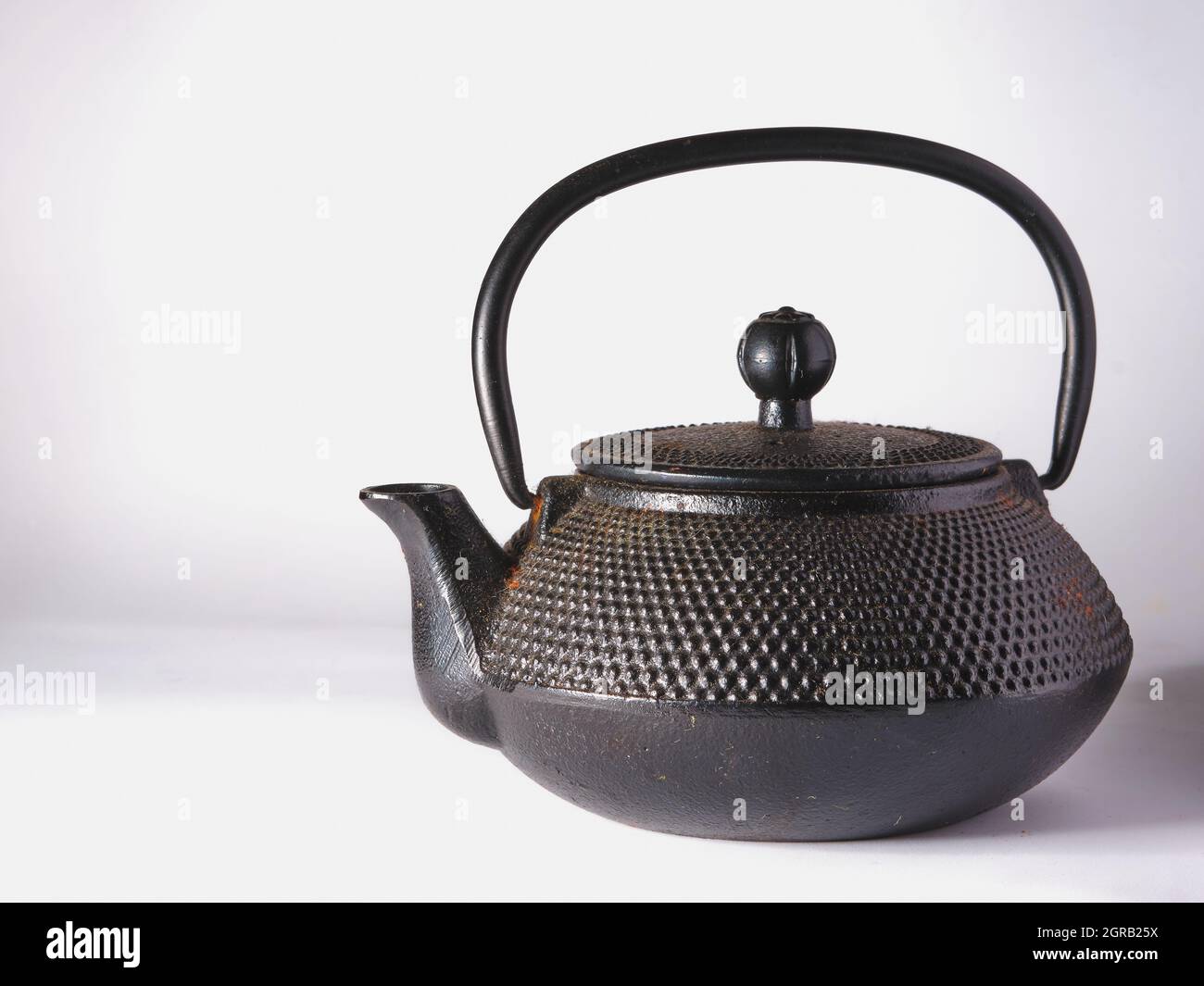 Black cast iron teapot on a white background Stock Photo Alamy