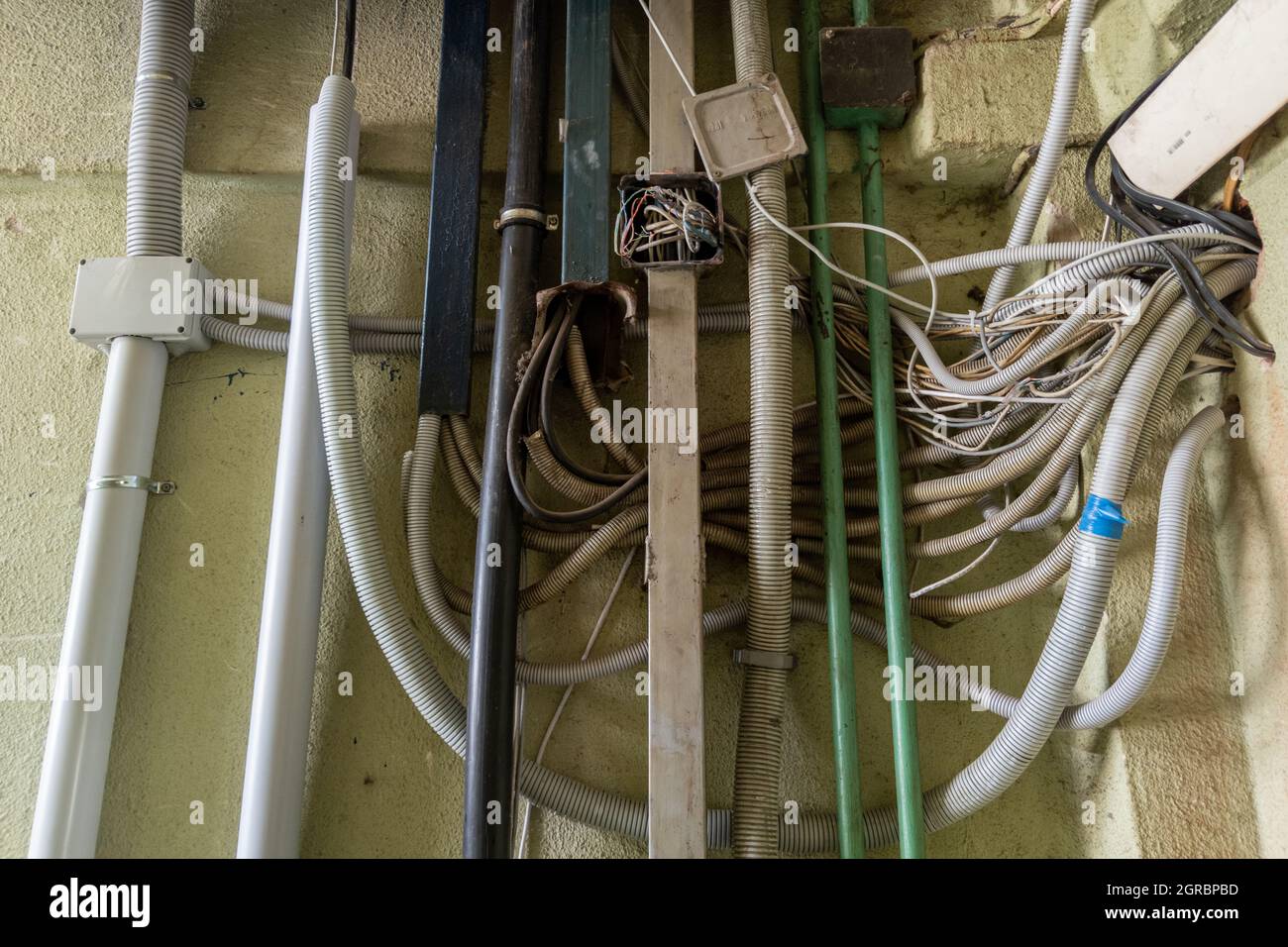 Messy And Careless Wiring Inside Of Public Building Stock Photo