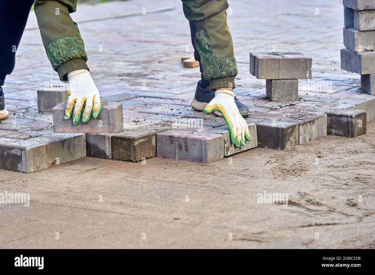 laying paving slabs on the sand with your hands Stock Photo Alamy