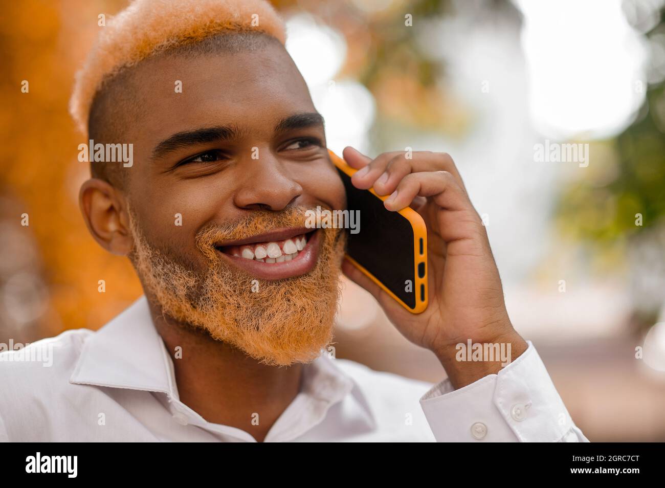A positive good-looking stylish man with a smartphone Stock Photo