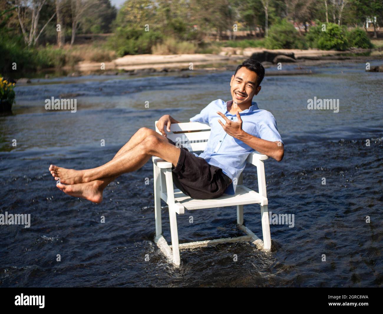 Young man reading beach chair alone hires stock photography and images