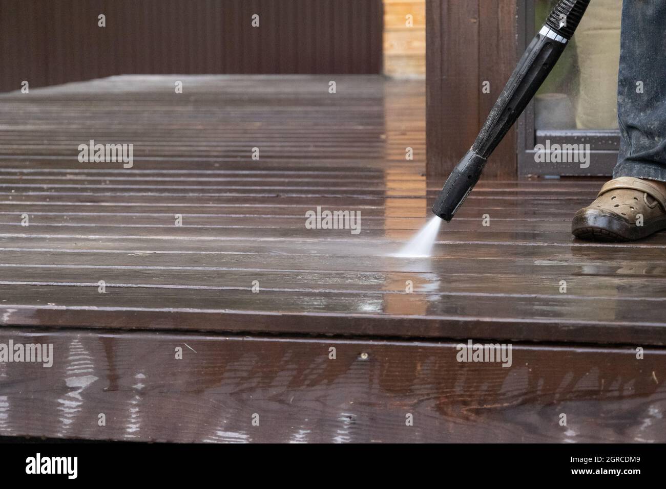 Man Cleaning Walls And Floor With High Pressure Power Washer. Washing