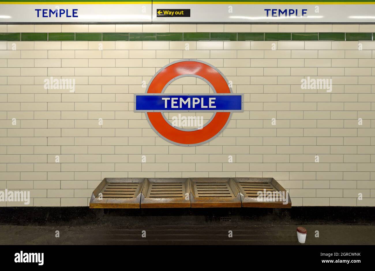 London, England, UK. Temple underground station - roundel and bench on the platform Stock Photo