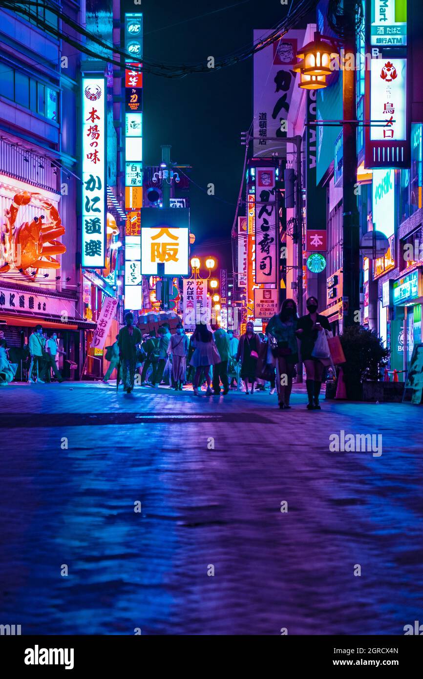 The view of Dotonbori street at night in Osaka-Kobe Japan with the cyberpunk color style. Cyberpunk color for night street photography. Stock Photo