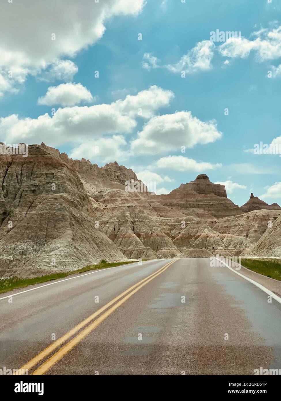 Empty Road By Mountains Against Sky Stock Photo