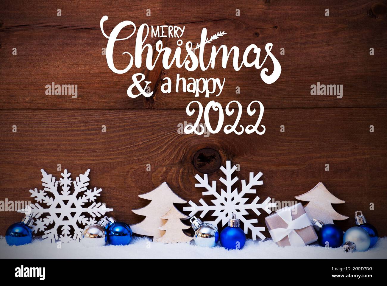 Calligraphy Merry Christmas 2022 English Calligraphy Merry Christmas And Happy 2022. Blue Christmas  Decoration Like Tree, Gift And Ball. Wooden Background With Snow Stock  Photo - Alamy