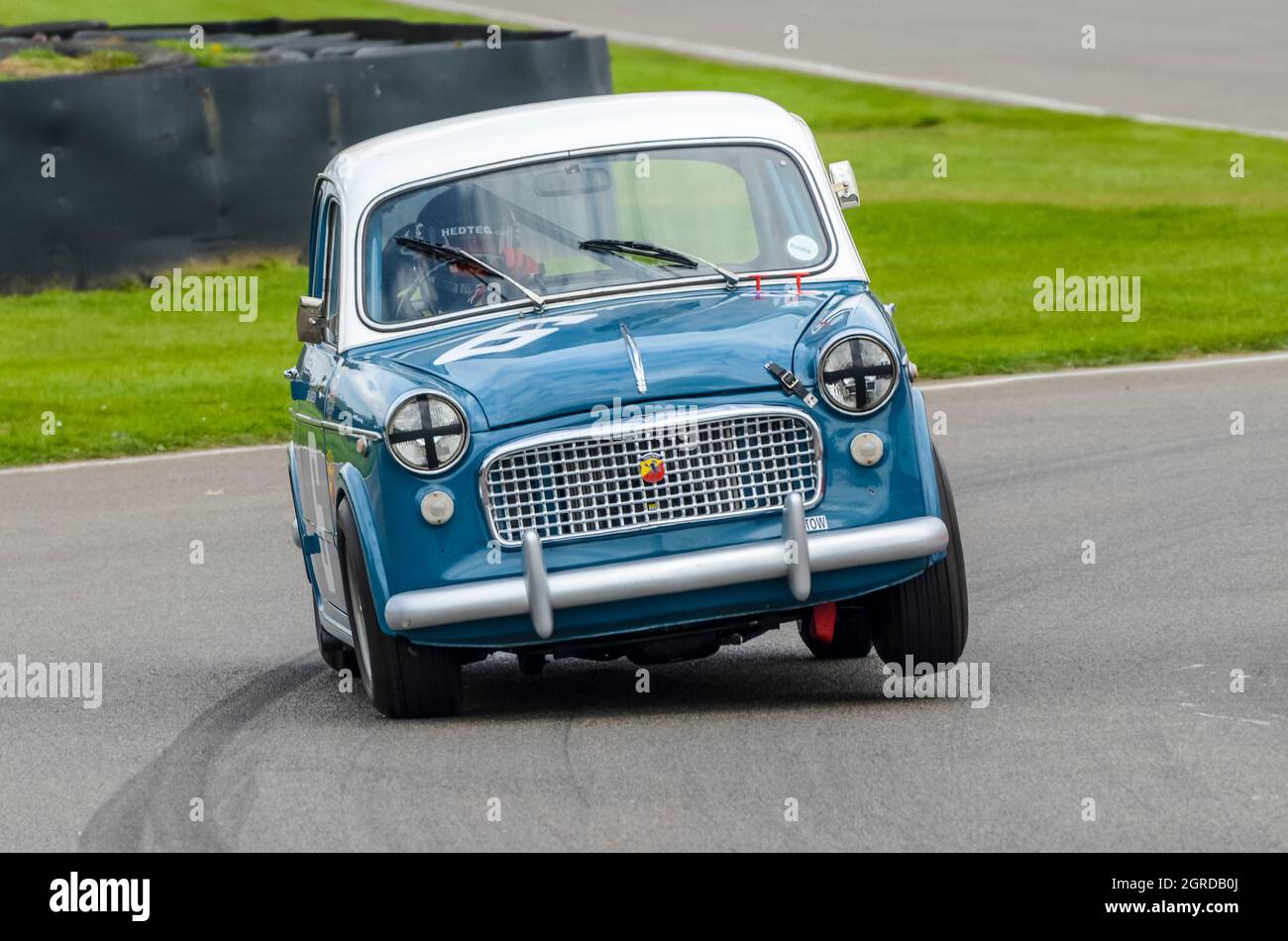 FIAT 1100 classic, vintage race car, racing in the St Mary’s Trophy for 1950s production saloons at the Goodwood Revival 2014. Cornering at speed Stock Photo