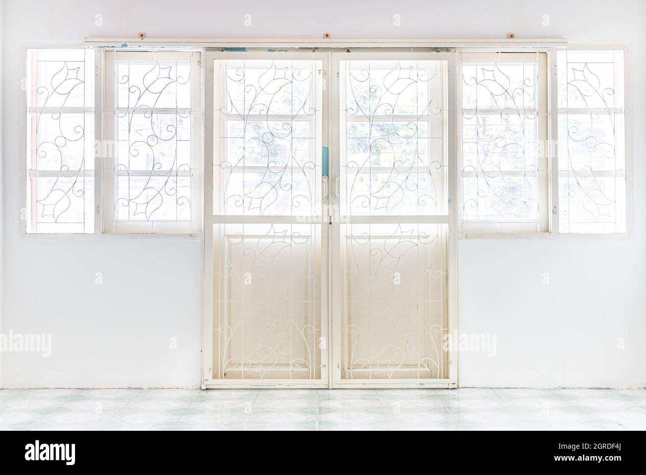 White Wrought Iron Door In White Wall Stock Photo - Alamy