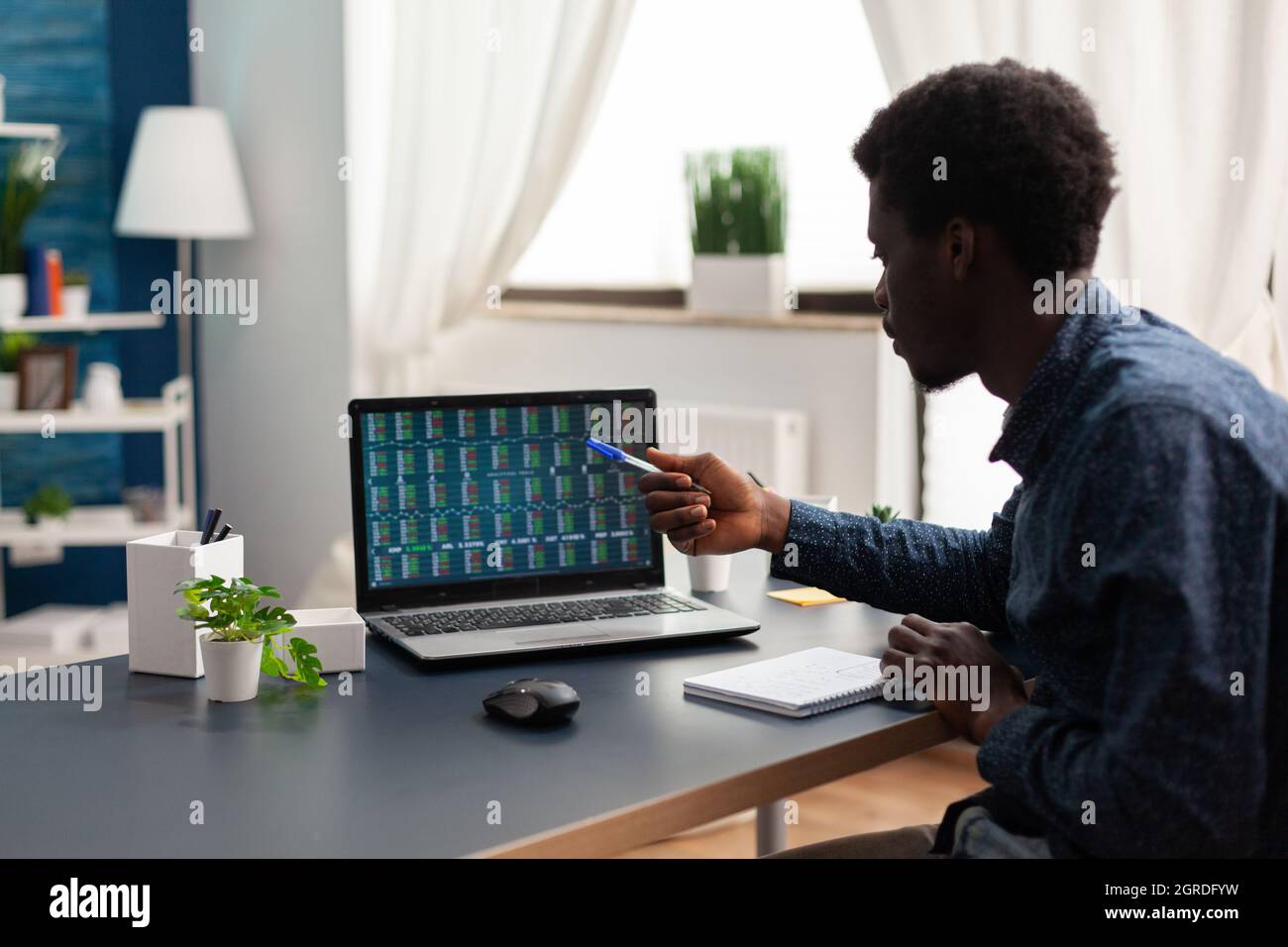 Student investor doing market analysis working at cryptocurrency report  analyzing blockchain chartsusing laptop in living room. Stock market  exchange trading crypto currency on screen Stock Photo - Alamy