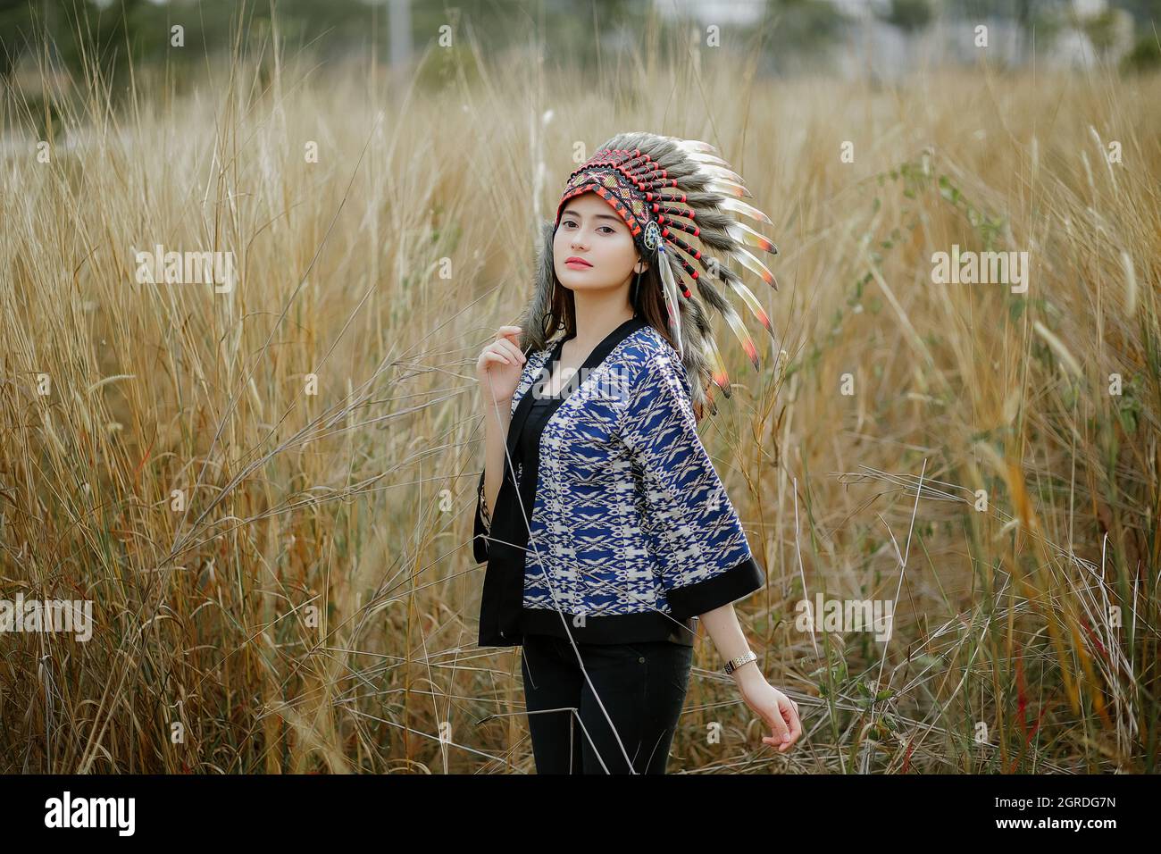 Young Woman Standing On Field Stock Photo