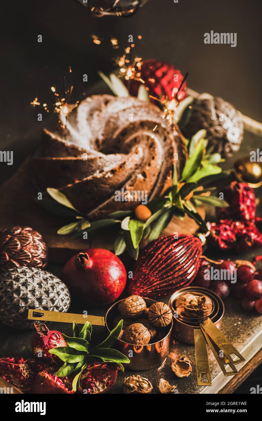 Christmas bundt cake with sparklers and holiday baubles on table Stock Photo