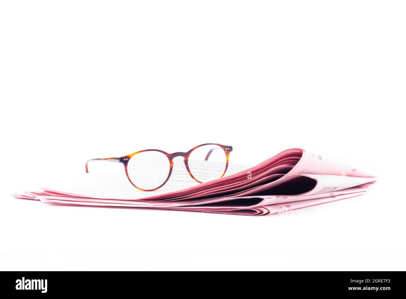 Italian sport newspapers and reading glasses isolated on white background Stock Photo