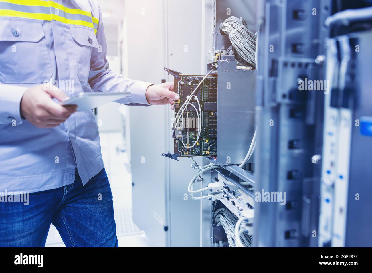 Technician Using Digital Tablet In Server Room, Repair Card Mainboard  Checking Network Link Status Stock Photo - Alamy