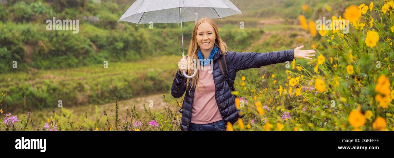 BANNER, LONG FORMAT Woman tourist with umbrella in Sapa in the fog, Northwest Vietnam. Vietnam travel concept. UNESCO heritage. Vietnam opens to Stock Photo