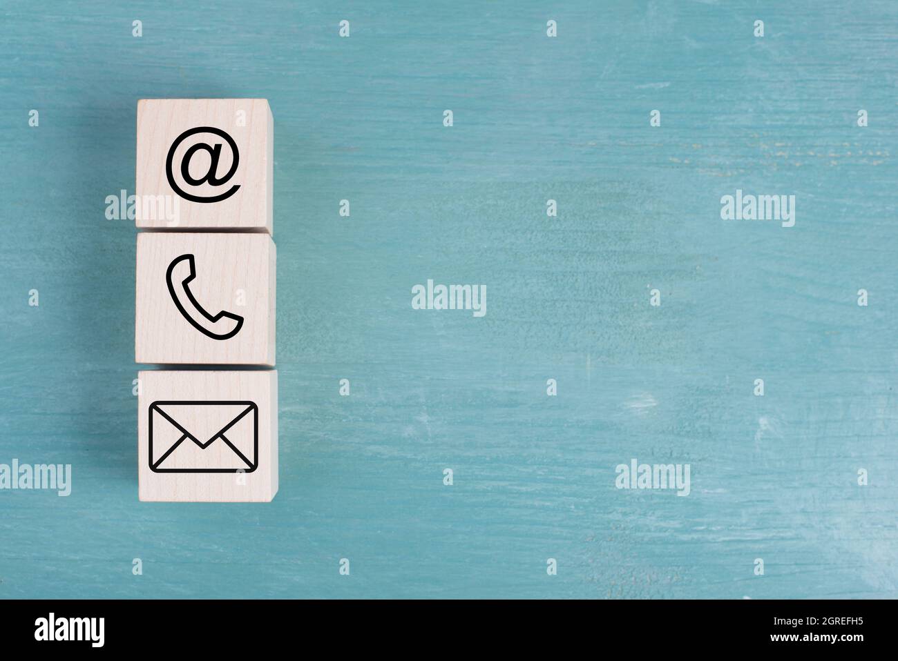 Signs for e-mail, phone and newsletter on wooden blocks, blue ...