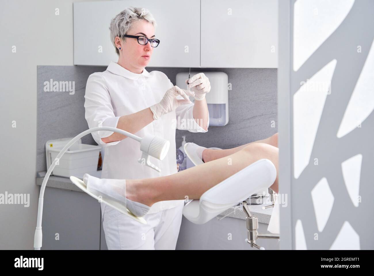 Midsection Of Woman Sitting On Chair Stock Photo. 