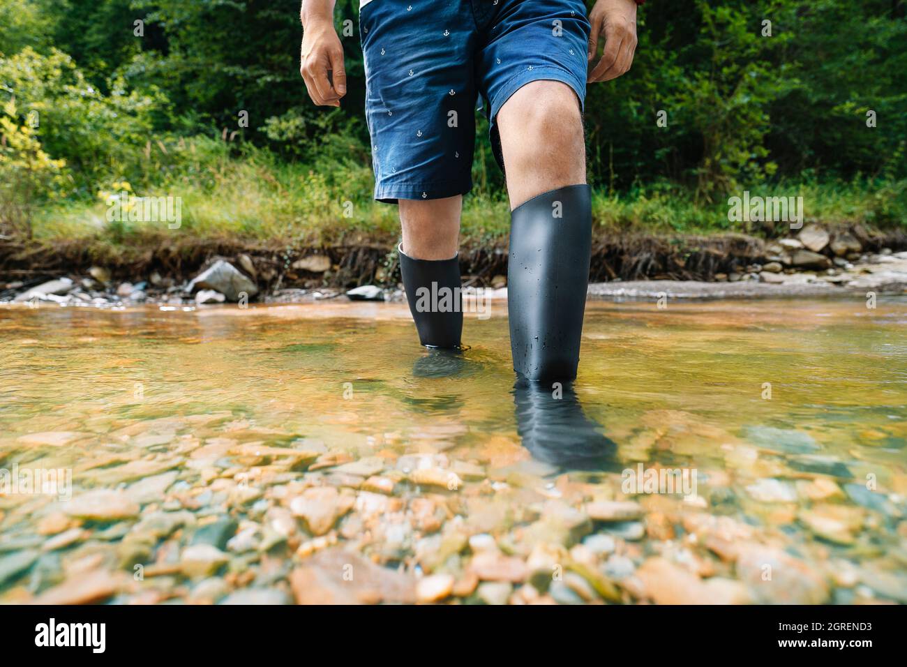 Man In Rubber Boots Walking In The River Stock Photo - Alamy