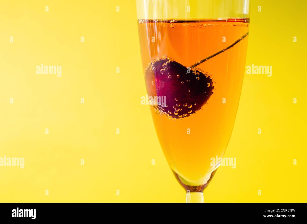 A Glass Of Sparkling Rose Wine With Cherry Fruit Served As A