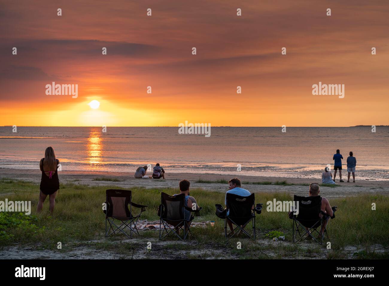 Tourist gathering daily on the beach to watch the sunset over Albatross Bay, Weipa, Far North Queensland Stock Photo