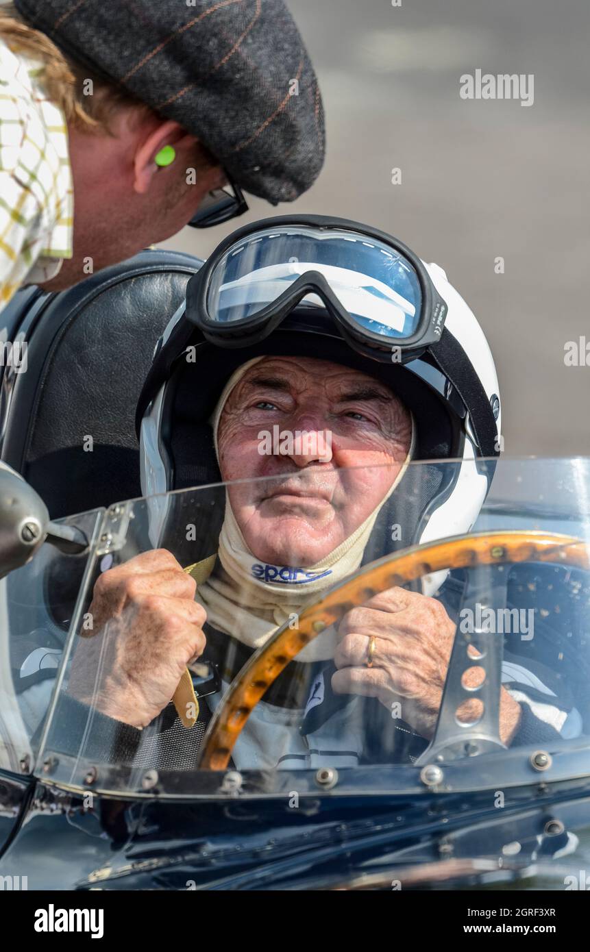 Nick Mason in a Jaguar D Type classic, vintage race car, after racing in the Lavant Cup at the Goodwood Revival 2014. Pit crew. Pink Floyd drummer Stock Photo