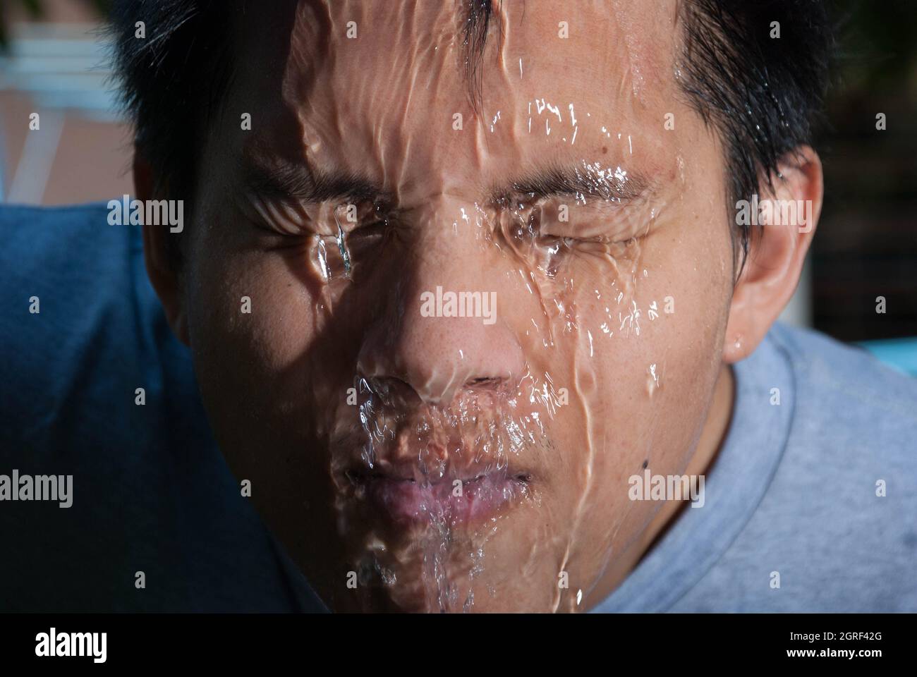 Mid adult man washing his face hi-res stock photography and images - Alamy