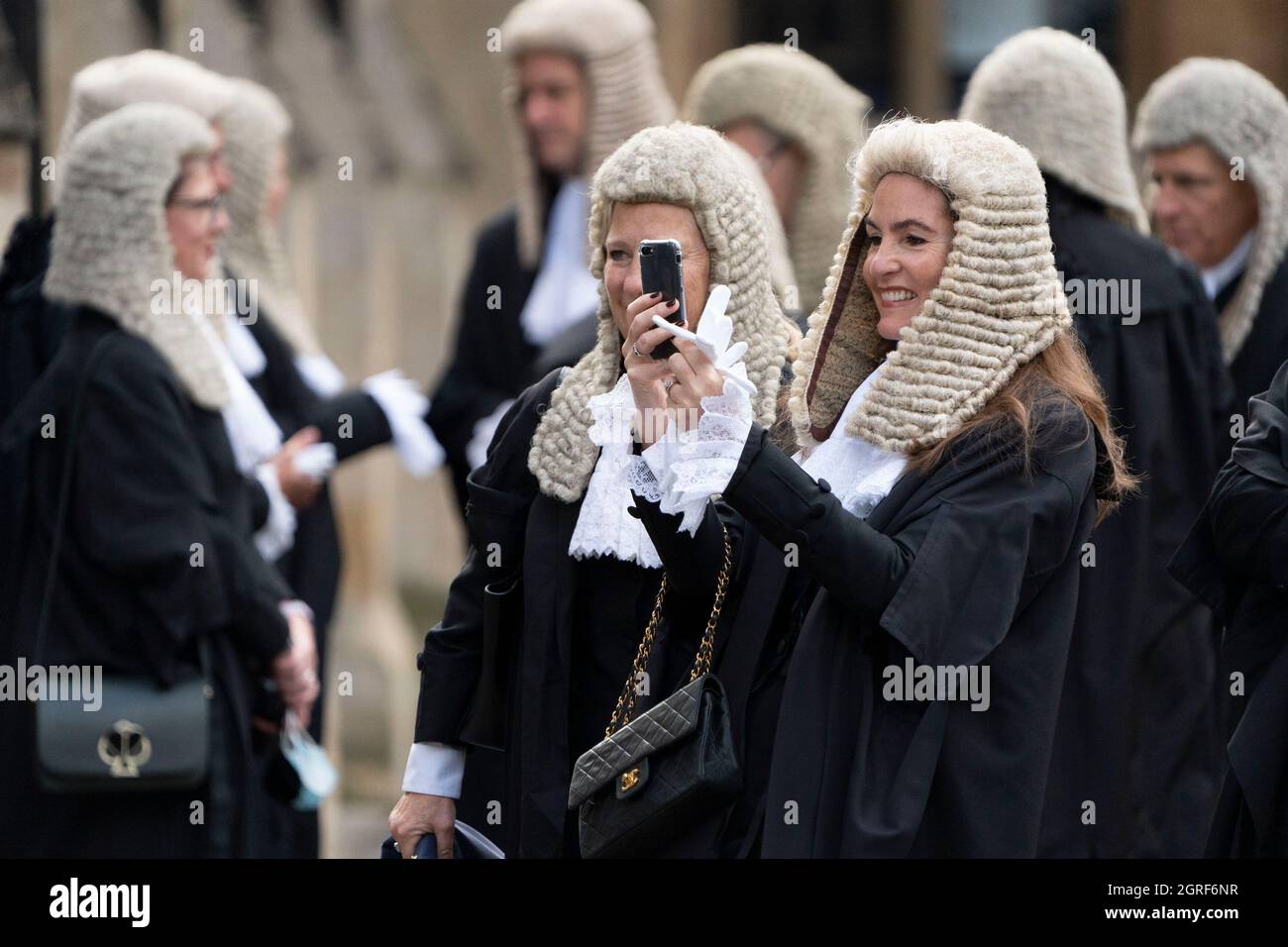 LONDON - OCTOBER 1: A member of the Judiciary takes a photo of her colleagues wearing their robe of office. The annual Judges Service took place at Westminster Abbey in London today, October 1, 2021. At the start of the legal year the Lord Chancellor, Dominic Raab wearing the robes of his office as Lord Chancellor, arrives at Westminster Abbey. Judges, Q.CÕs and senior legal figures, walk in a procession from Westminster Abbey to the Houses of Parliament, for a reception hosted by the Lord Chancellor. The custom dates back to the Middle Ages, when the judges prayed for guidance at the start of Stock Photo