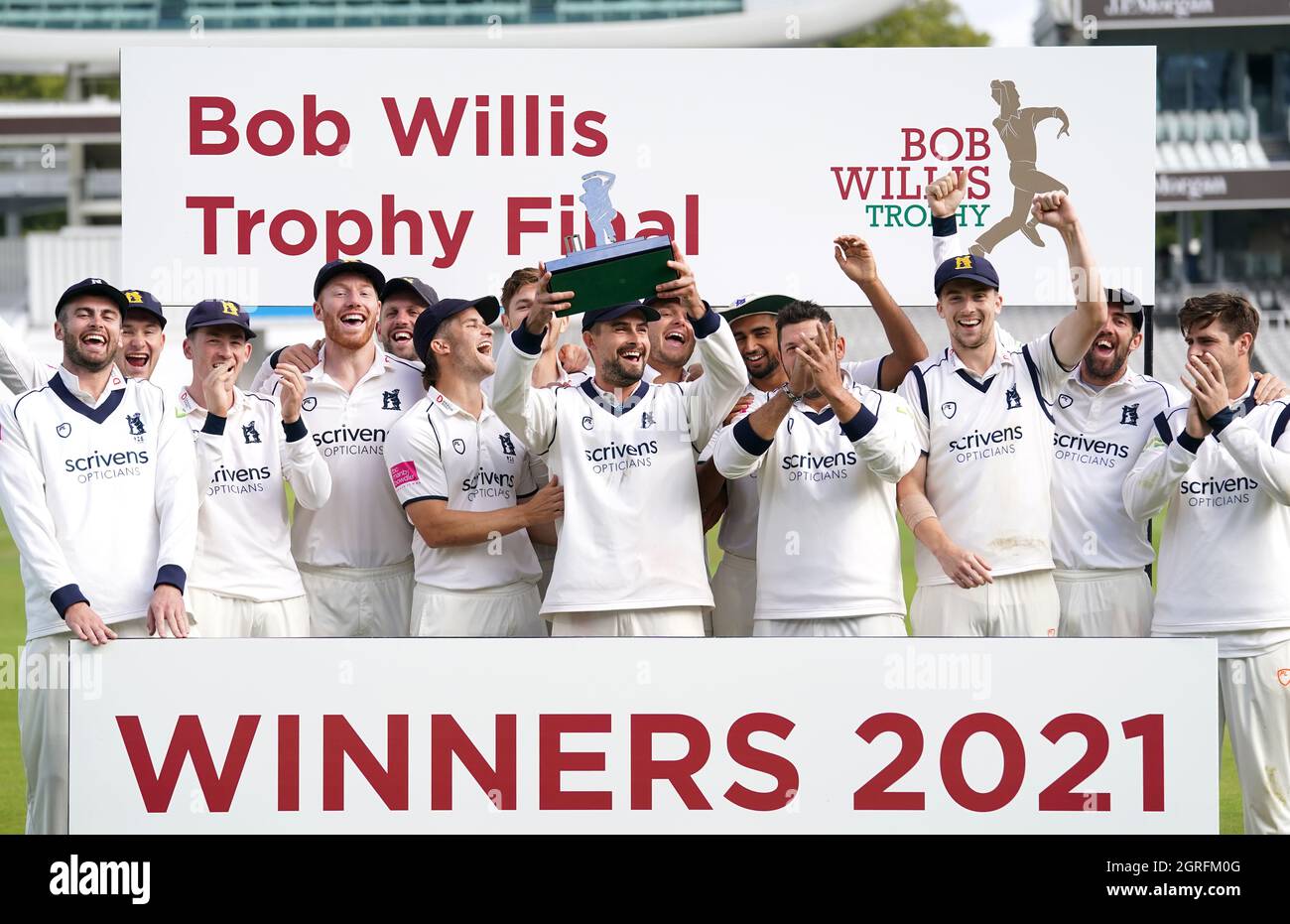 Warwickshire captain Will Rhodes holds the trophy after winning the Bob ...