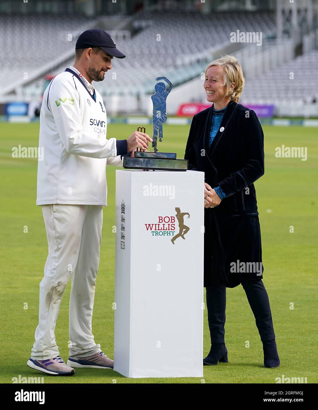 Warwickshire captain Will Rhodes receives the trophy from Lauren Clark ...