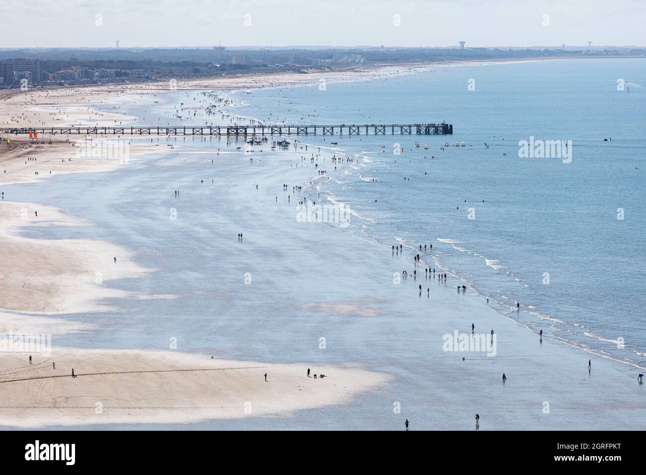 France, Vendee, St Jean de Monts, walkers and bathers on the beach and the jetty (aerial view) Stock Photo