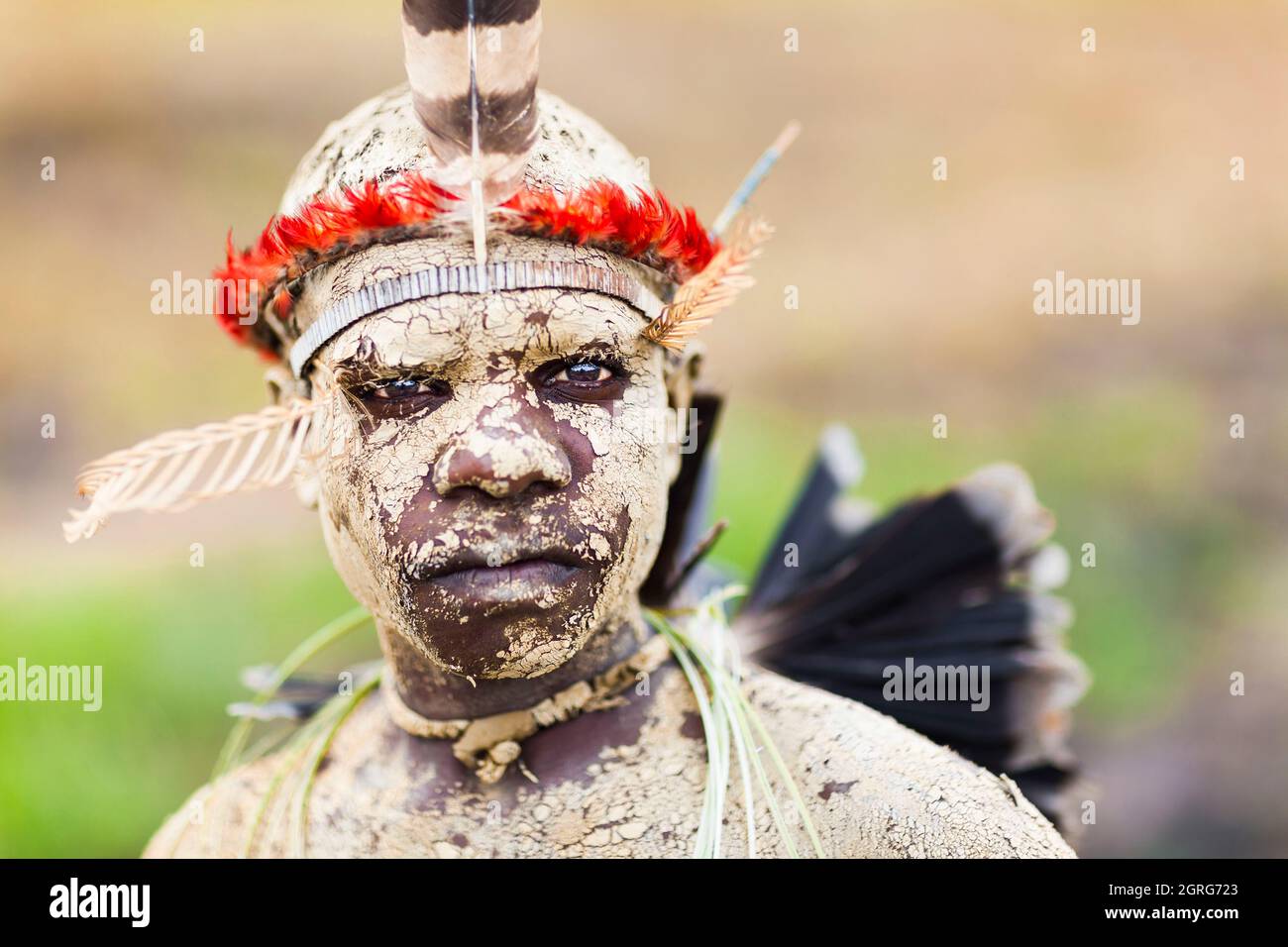 Indonesia, Papua, city of Wamena, portrait of a young Dani boy, face and body made up with earth. Baliem Valley Cultural Festival, every August, tribes come together to perform ancestral war scenes, parade and dance in traditional clothes Stock Photo
