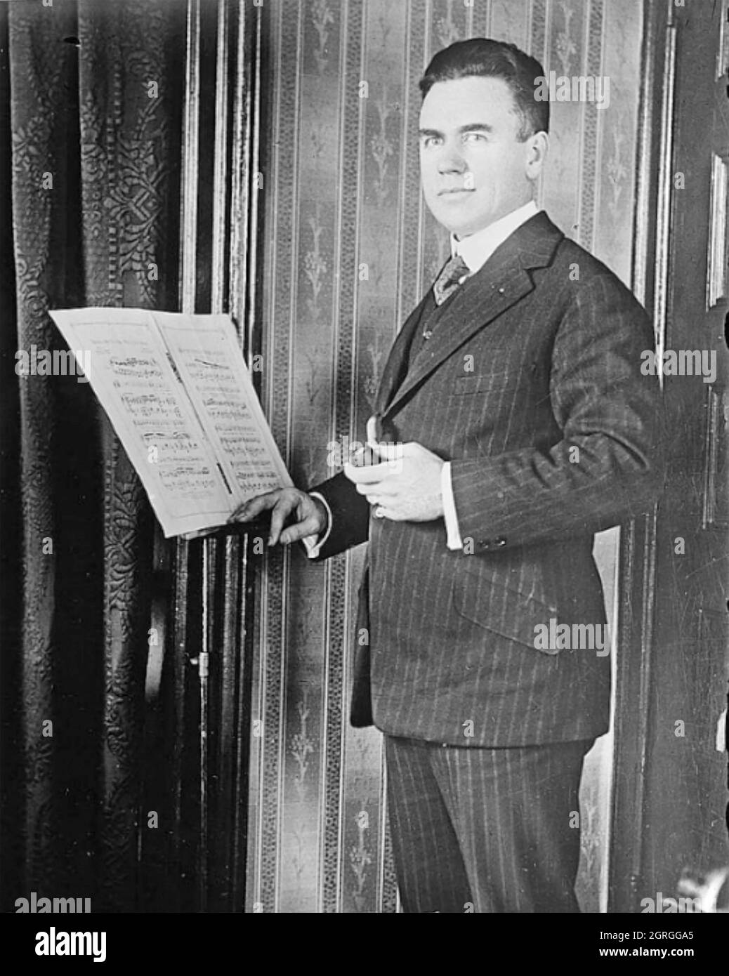 VERNON DALHART (1883-1948) American country music singer/songwriter with the score of his classic ballad 'Wreck of the Old 97' in 1924 Stock Photo