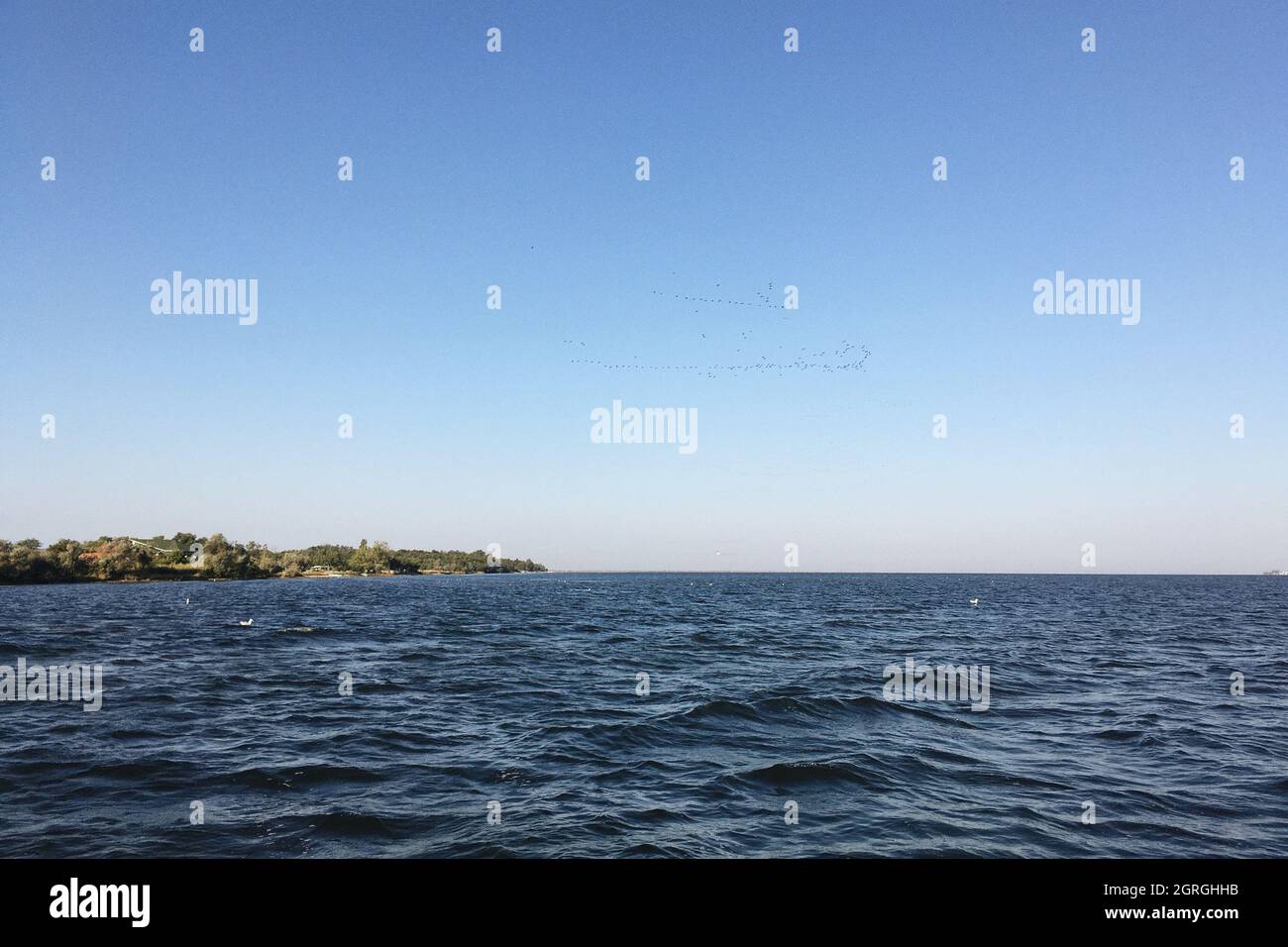 Scenic View Of Sea Against Clear Blue Sky Stock Photo
