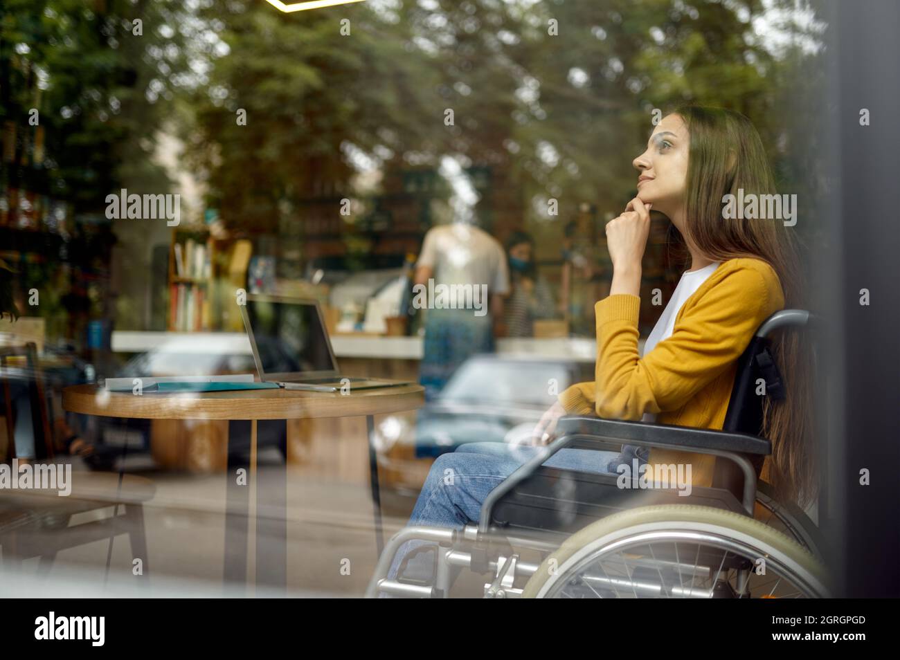 Disabled student in wheelchair, window view Stock Photo - Alamy