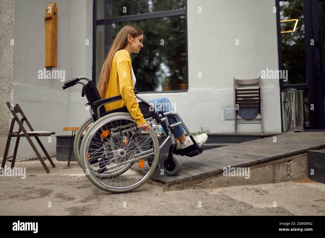 Disabled student in wheelchair at the ramp in cafe Stock Photo - Alamy