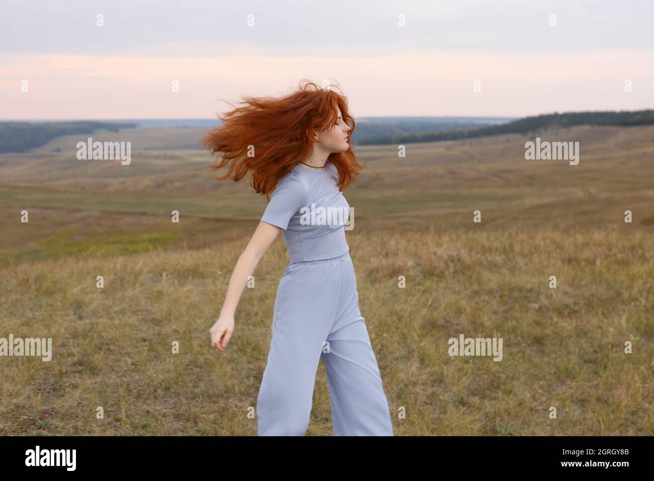 Redhead teen girl with hair fluttering in the wind Stock Photo