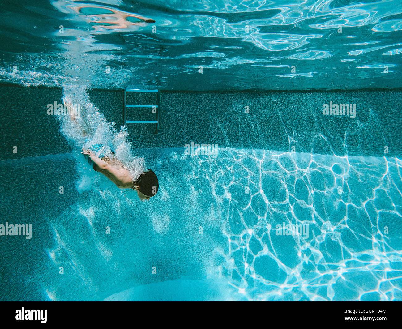 Underwater image of a boy diving into a swimming pool Stock Photo Alamy