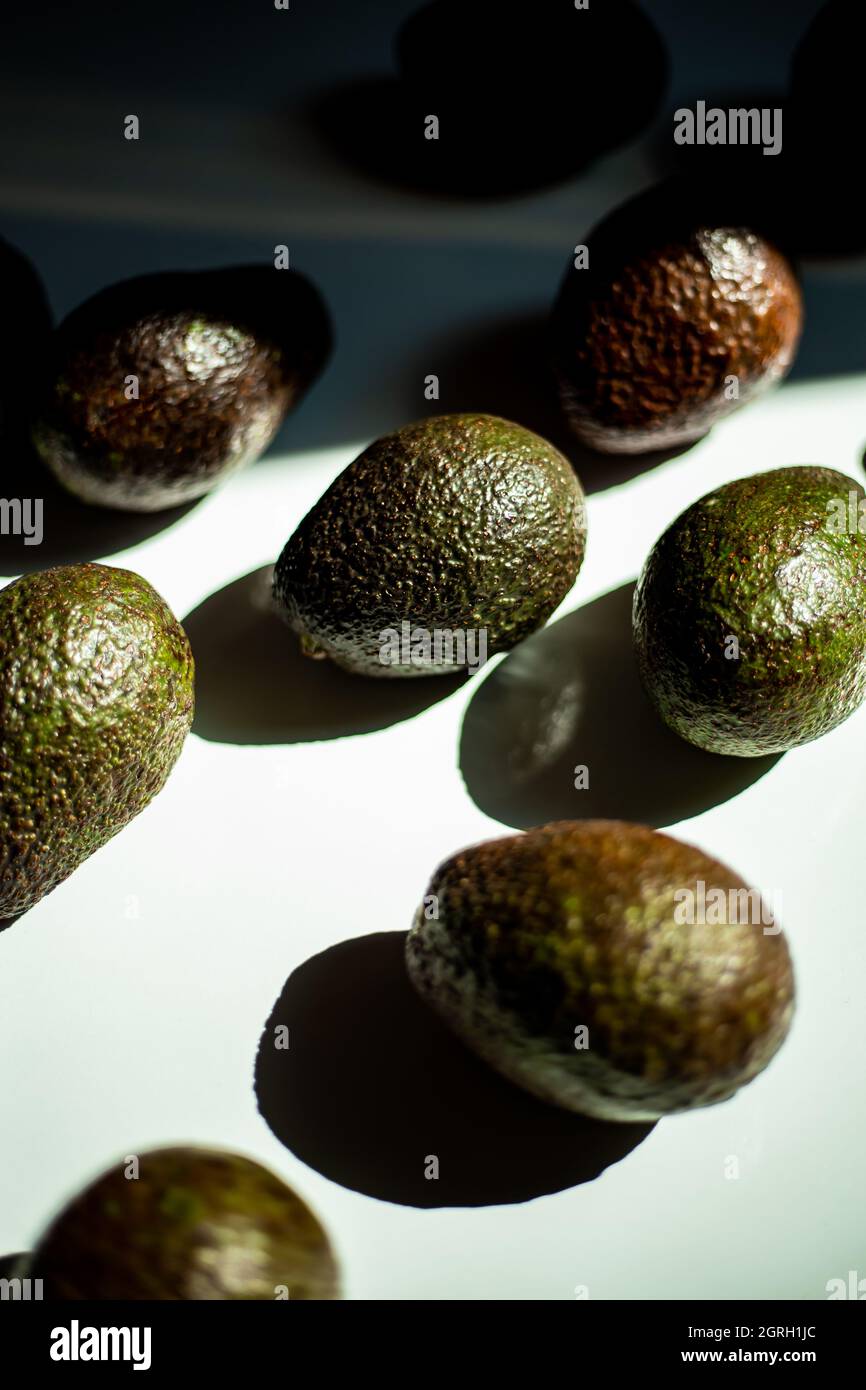 Many avocados on white background Stock Photo - Alamy