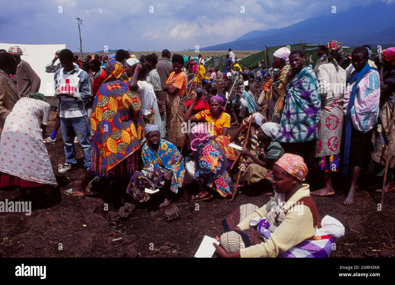Rwandan women refugees in a camp in Goma in the Democratic Republic of Congo wait in line for food relief from an aid development agency. Stock Photo