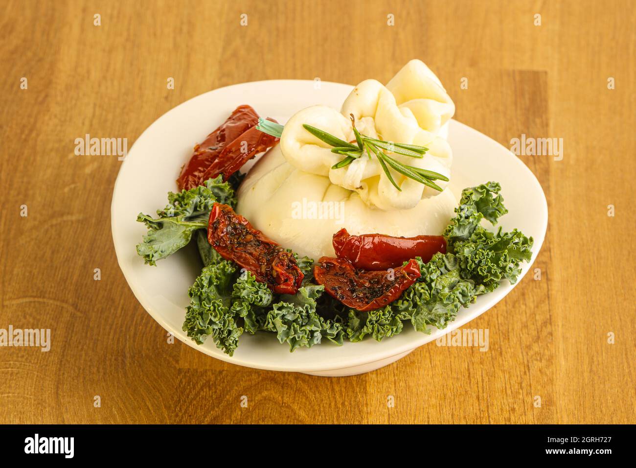 Burrata young cheese with sun dried tomato Stock Photo Alamy