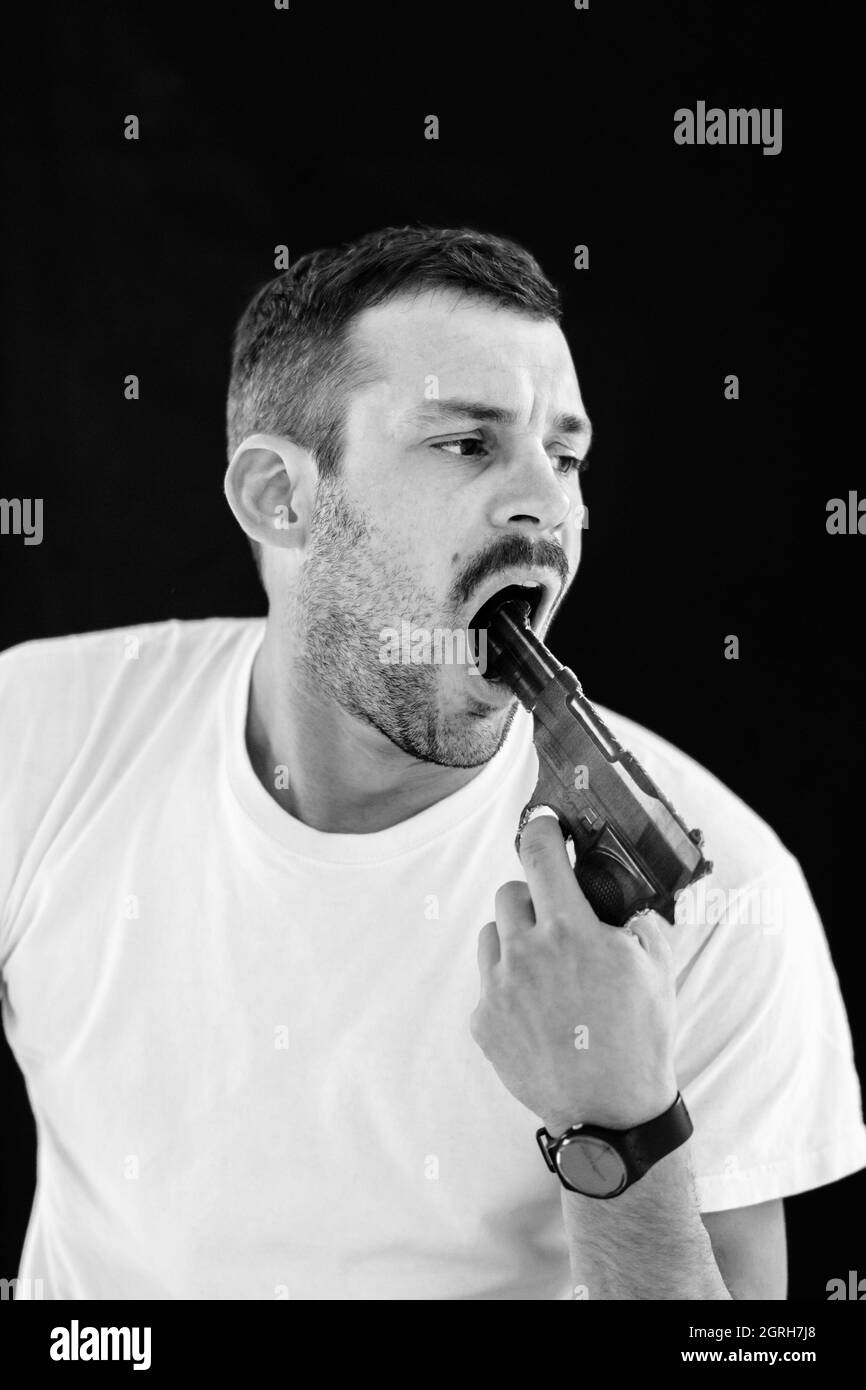 Man Pointing Gun In Mouth Against Black Background Stock Photo Alamy